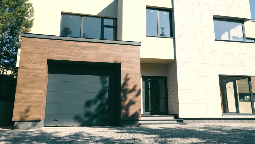 Modern exterior of the house. house with its own territory and large panoramic windows. A small suburban house in a modern style. | Shutterstock HD Video #1082001266