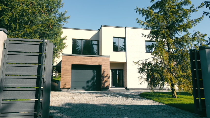 Modern exterior of the house. house with its own territory and large panoramic windows. A small suburban house in a modern style. Royalty-Free Stock Footage #1082001266
