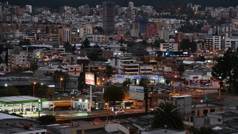 QUITO, ECUADOR - NOVEMBER 7, 2021: Timelapse of modern district in Quito from sunset to night with rush hour traffic movement.