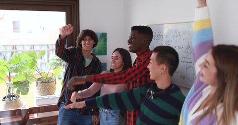 Young people stacking hands together