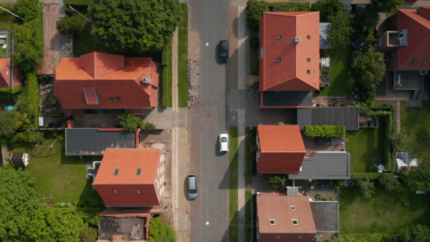 Aerial birds eye overhead view of Esbjerg, Denmark. Top down slow flight view pedestrian strolling down the road and car parked in parking lot Royalty-Free Stock Footage #1082003774