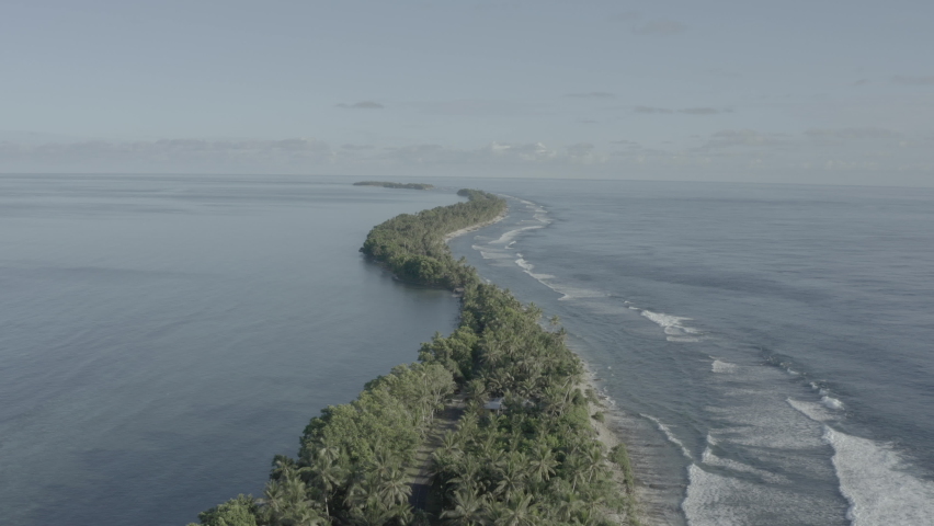 Drone footage of Pacific Island nation Tuvalu which is suffering from climate change and rising sea waters. A beautiful beachside and city landscape that is afflicted with a modern problem. Royalty-Free Stock Footage #1082004152