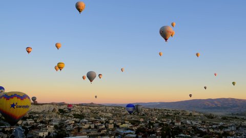 Gerime, Turkey - CIRCA 2021: Timelapse of balloons at sunrise. Many balloonists at work, ride tourists in most touristic place in Turkey in region of Cappadocia.
