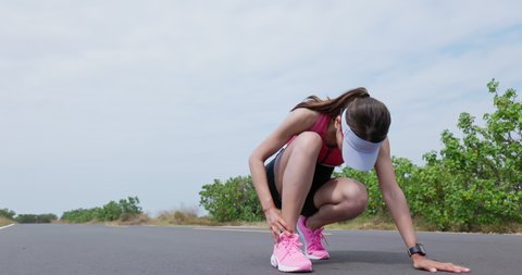 asian woman is running on road training for triathlon or healthy lifestyle and she has ankle pain