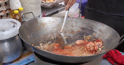 The best street food Pad thai favorite and famous Asian. Chef cooking Pad Thai food night market. 