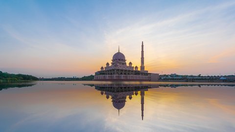 Beautiful cleary sunrise Time Lapse at Putra mosque by Putrajaya lake in Putrajaya, Malaysia at dawn. Zoom out motion timelapse. Prores 4K
