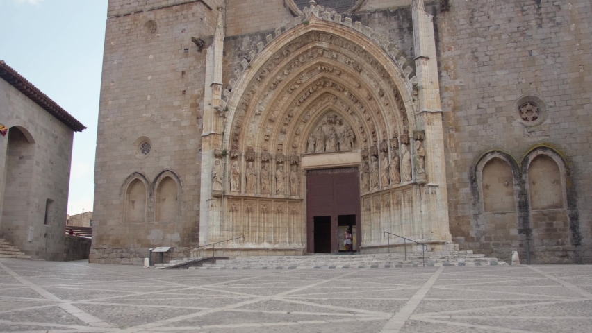 Tourist visiting the Santa Maria de Castelló in in Castellon de Ampurias, Costa Brava, Spain -Wide