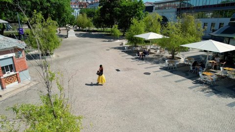 Aerial drone view of a woman walking in the Jardim de Roque Gameiro park, in Cais do Sodre, Lisbon