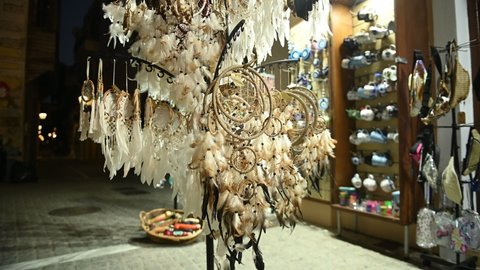 Colourful dreamcatchers moving in the wind outside of shop