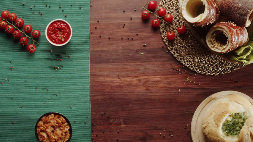 Putting fried sausages and smoked ribs top view. Cafe restaurant with european gastronomy food. Traditional czech cuisine. Bratwursts, meat with sauce and opened soup in bread. Fresh baked Trdelnik. 