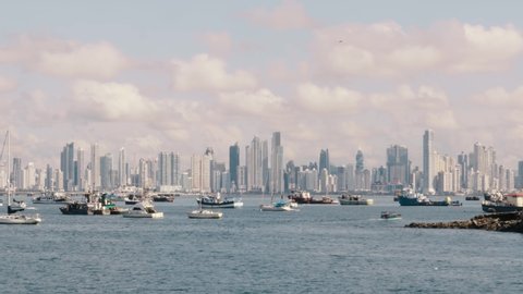 Timelapse overlooking the boats moored in the Panama Canal marina, in the distance a scenic backdrop of the spectacular modern buildings and beautiful cityscape of Panama City