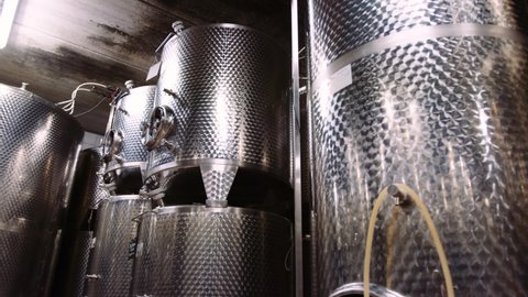 Shiny stainless steel tanks in wine-cellar used for wine fermentation, tilt-up
