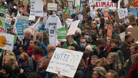 Amsterdam, Netherlands, November 6, 2021. Packed crowd holding protest signs during Climate March. 