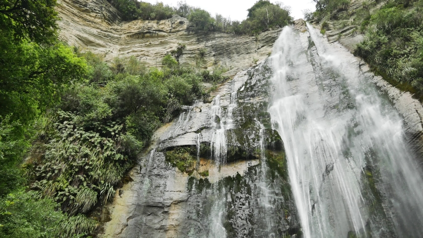 New Zealand Tall Cliff Waterfall in Hawkes Bay, Low Angle Waterfall Looking Up