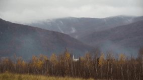 Timelapse of an autumn landscape with fog in a mountainous area