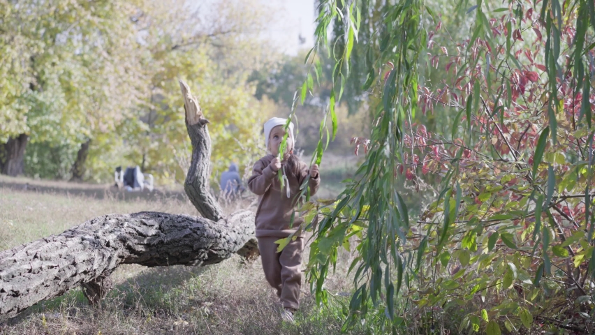 Little happy girl outdoor. Happy fun cheerful girl having fun in park Autumn season. High quality 4k footage
