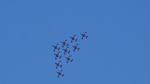 Thiene Vicenza Italy OCTOBER, 16, 2021 Huge military acrobatic team of 10 planes in flight in narrow formation in blue sky demonstrating teamwork skills. Aermacchi MB-339 of Frecce Tricolori