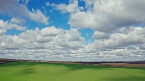 Aerial video filming of fields, sky and clouds.
