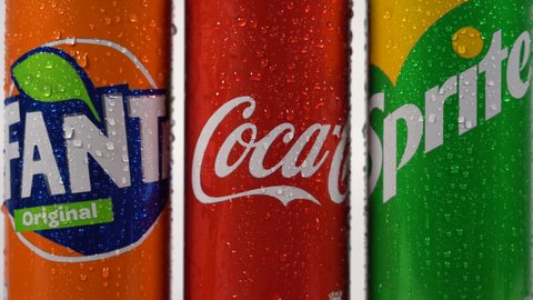 Europe, Italy , Milan November 2021 - Can of Coca-cola , Fanta and Sprite  carbonated soft drink logo close-up : the most famous  can in the world with fresh drops of water