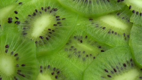 Background in the form of sliced kiwi spins, juicy green kiwi fruit or chinese gooseberry