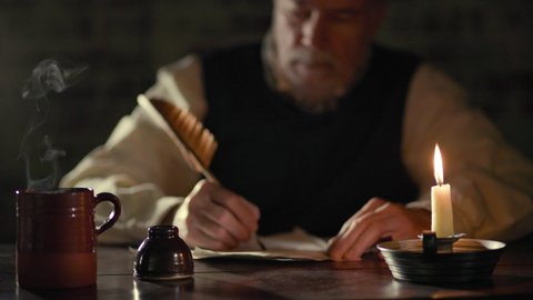Scene of a mature man in the 18th century lit by candlelight sitting at a desk with a hot beverage writing with a quill pen.