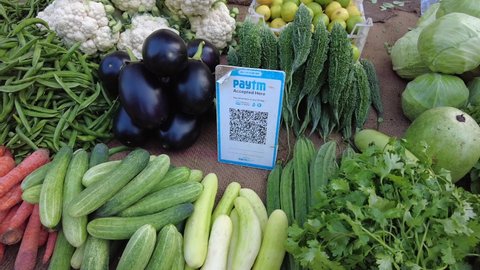 Pune, India - November 10 2021: A QR code for payments among fresh vegetables at a roadside vegetable stall at Pune India.