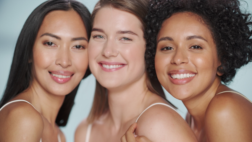 Beauty Portrait of Three Diverse Multiethnic Models on Isolated Background. Fun Joyful Asian, Black and Caucasian Women with Natural, Healthy Skin. Wellness, Spa, Cosmetology, Skincare Concept.
