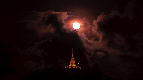 Pagoda Khao Hua Jook, the fullmoon move over Golden pagoda with warm cloud , twilight sky to moon night sky at Chaweng , Koh samui , suratthani , thailand