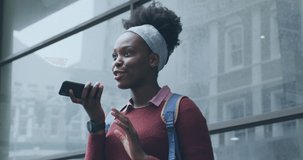 Animation of social media notifications over african american woman talking on smartphone in city. global communication technology and social network concept digitally generated video.