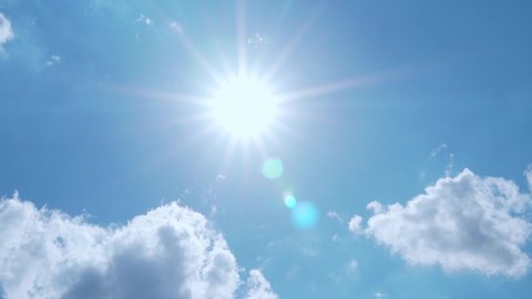 Sun With Rays and Glare, Blue Clear Sky and Clouds, Slow Motion, Time Lapse. Sunlight in an Azure Sky with Cumulus White Clouds in Sunny Bright Weather. Natural Background 4K. Adlı Stok Video