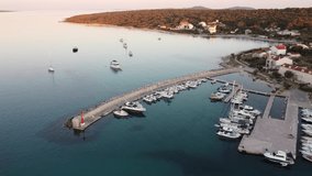 Sunset aerial view of Croatian island Silba with beautiful Sotorisce bay. Amazing Adriatic sea tourist vacation destination in Croatia. Panoramic paradise blue sea, sandy beaches, old houses and boats