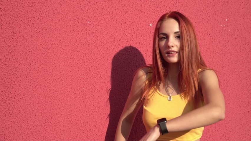 Young sexy woman dancing hip hop in the street, slow motion. Modern creative youth. Street subculture