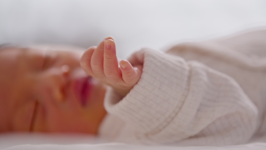 Close up hand of happy newborn baby lying sleeps on a white blanket comfortable and safety.Cute Asian newborn sleeping and napping on bed.Newborn Baby photography concept | Shutterstock HD Video #1082090426