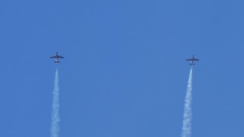 Thiene Vicenza Italy OCTOBER, 16, 2021 Perfect synchronization of two aerobatic airplanes performing a loop in the blue sky. Aermacchi MB-339 of Frecce Tricolori the Italian Aerobatic Team