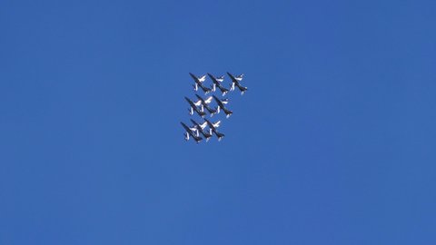 Thiene Vicenza Italy OCTOBER, 16, 2021 Acrobatic team of nine aircrafts in close diamond formation does a roll in a perfectly blue sky. Aermacchi MB-339 of Frecce Tricolori