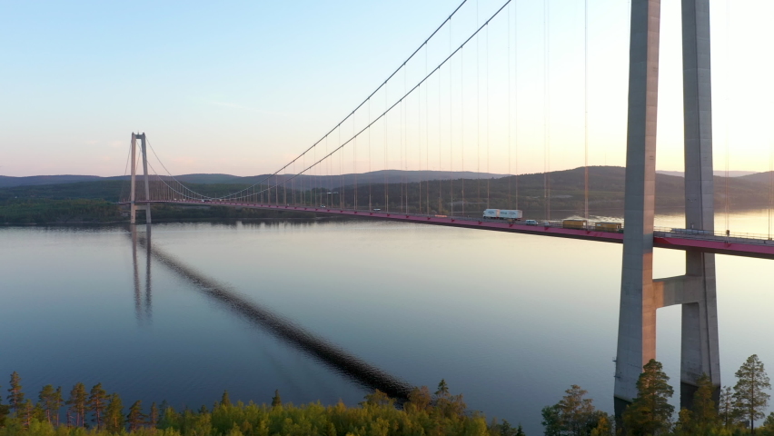 Traffic on High Coast bridge in Sweden. Aerial drone view of the famous bridge in northern Sweden. Truck and cars on bridge.  | Shutterstock HD Video #1082103554