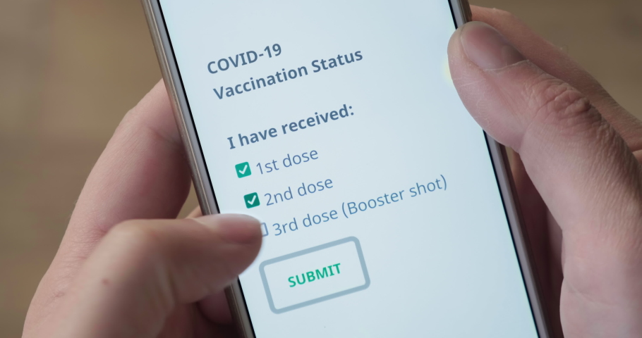 Concept of Covid-19 vaccinated status with hands ticking first, second and third (booster shot) doses on phone screen, after vaccination. POV, close up, coronavirus, form, app. Royalty-Free Stock Footage #1082116529