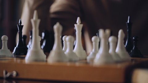 Male playing chess, thinking about game strategy or winning combination, hobby