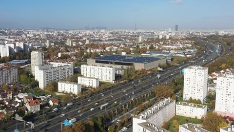 France, Paris suburb (Val-de-Marne district), L'Haÿ-les-Roses, HLM buildings around the A6a and A6b highway, Tour Montparnasse and Eiffel Tower in the back, La Defense in background, drone aerial view