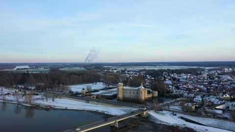 The town of Sully sur Loire, its castle and its nuclear power station in Europe, in France, in the Center region, in the Loiret, towards Orleans, in Winter, on a sunny day.