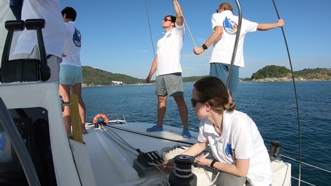 Phuket, Thailand, 25, February, 2019:
Yachting school student girl learning to work with running rigging