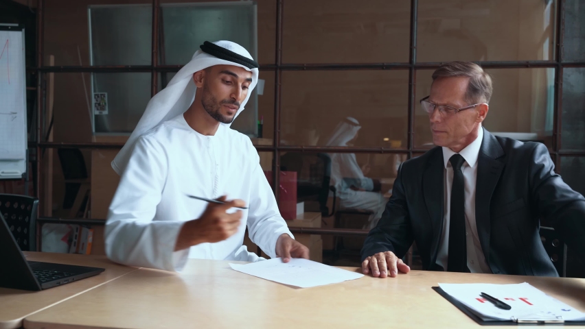 Cinematic footage of a multiethnic business group working together in an office of Dubai Royalty-Free Stock Footage #1082148560