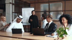 Cinematic footage of a multiethnic business group working together in an office of Dubai
