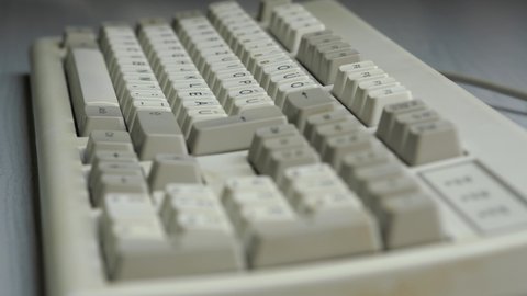 Typing on old PC computer keyboard (close up)
