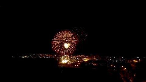 Irkutsk city. Russia. May 9 2021. Fireworks over the night sky of the city. Embankment of the Angara River. Shooting from a drone. View from above