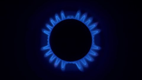 Gas burner. Blue flames of natural gas, seamless loop footage. Kitchen cooktop in the dark, view from top
