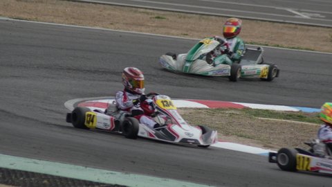 Karts running in a curve in a circuit