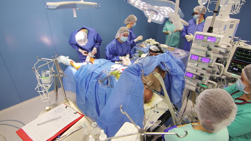 Team of professional doctors performing surgical operation in hospital. Elderly male patient undergoing heart surgery. Medical staff. Royalty-Free Stock Footage #1082163176