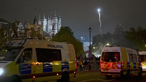 LONDON - NOVEMBER 5, 2021: Fireworks and Police Vans in Parliament Square at 2021 Million Mask March