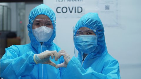 Ho Chi minh, Vietnam -21 september 2021: A doctor in a protective suit taking a throat swab and nasal swab from a possible coronavirus COVID 19 test for people.